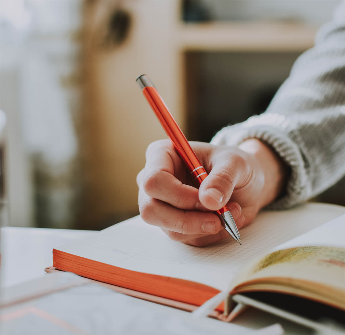Image of person writing down notes