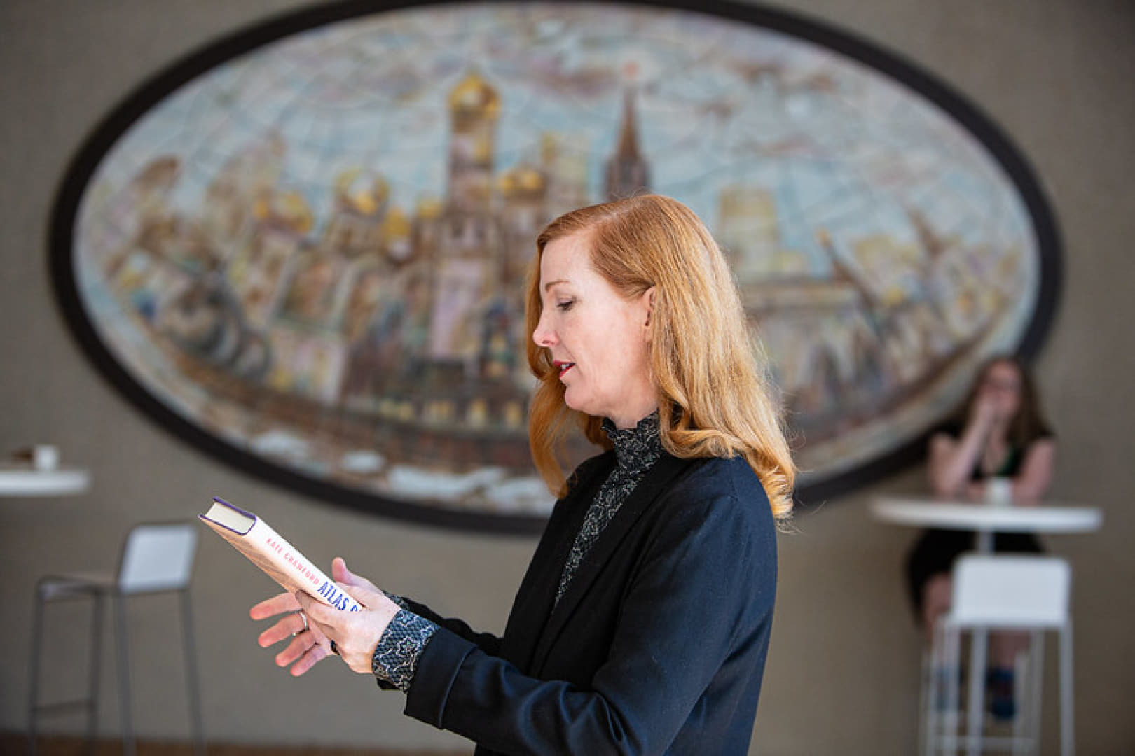 Portrait of an individual giving a presentation.