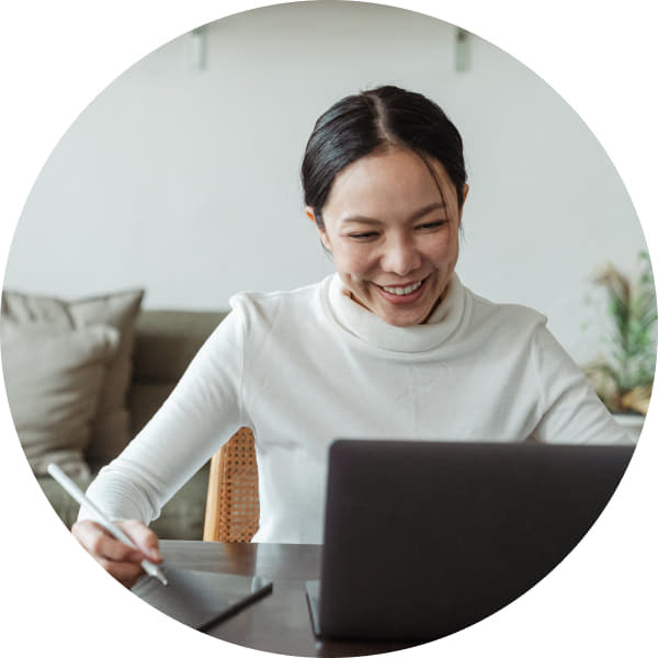 High-resolution image of an individual in a meeting on a laptop, emphasizing interconnected excellence.