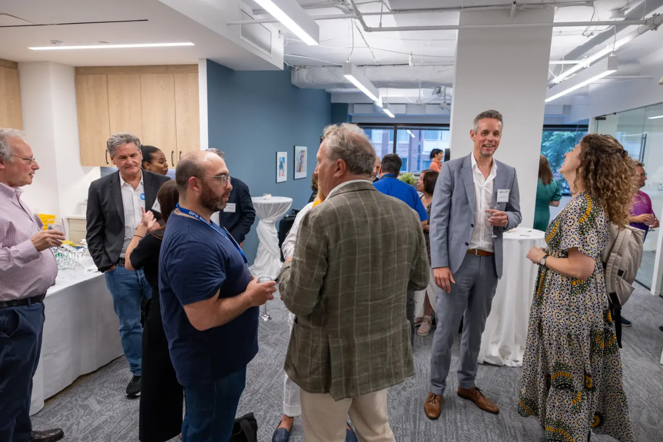 Image of the AFAvH office warming party, emphasizing discussions.