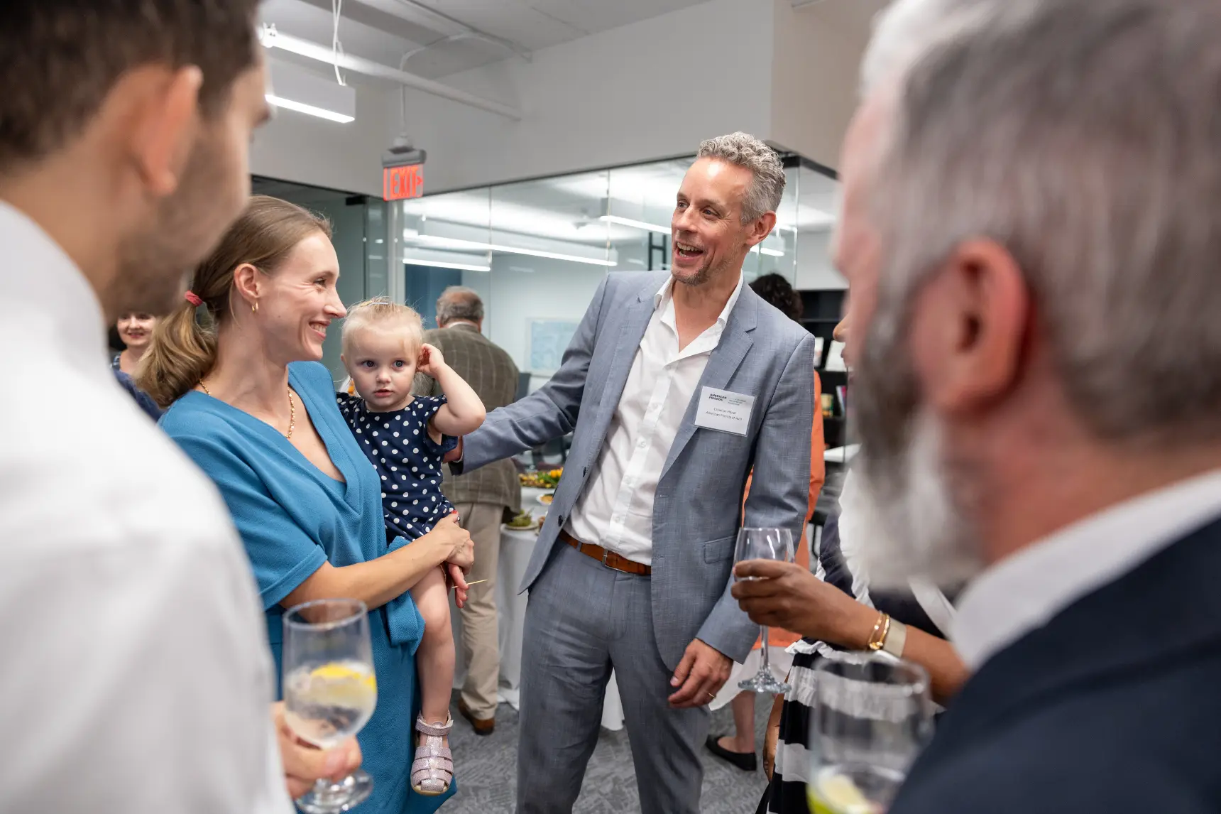 Image of the AFAvH office warming party, emphasizing discussions.