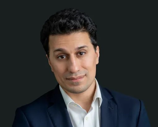 Cameron Abadi, a thought leader in research policy, in a professional headshot.